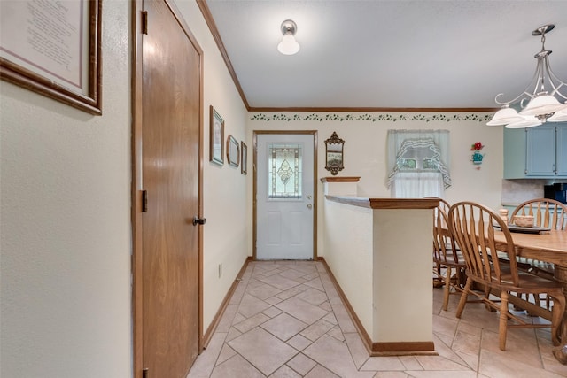 kitchen featuring ornamental molding, baseboards, pendant lighting, a chandelier, and blue cabinetry
