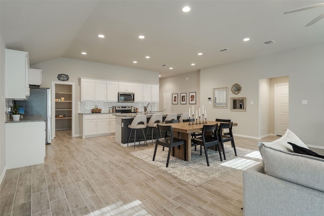 5753 Brookville Dr, Fort Worth, TX 76179 - dining space with recessed lighting, light wood-type flooring, lofted ceiling, baseboards, and a ceiling fan
