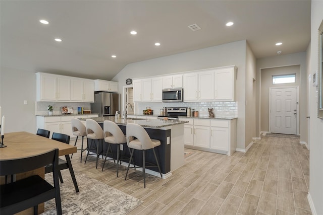 5753 Brookville Dr, Fort Worth, TX 76179 - kitchen featuring stainless steel appliances, a sink, tasteful backsplash, a center island with sink, and recessed lighting
