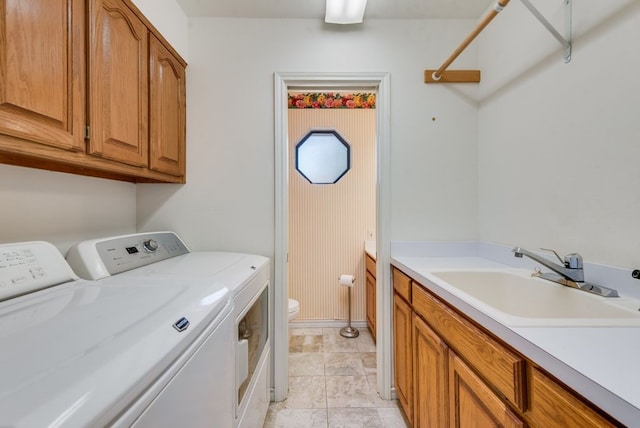 104 Kiowa Dr N, Gainesville, TX 76240 - washroom with baseboards, washer and dryer, and a sink