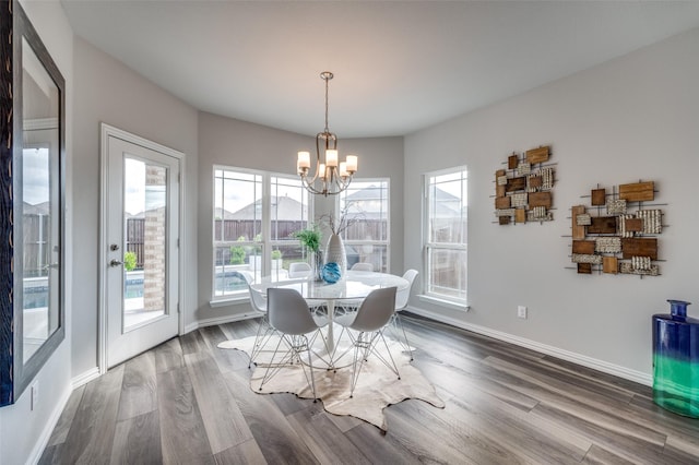 dining room featuring baseboards, dark wood-style floors, and a chandelier