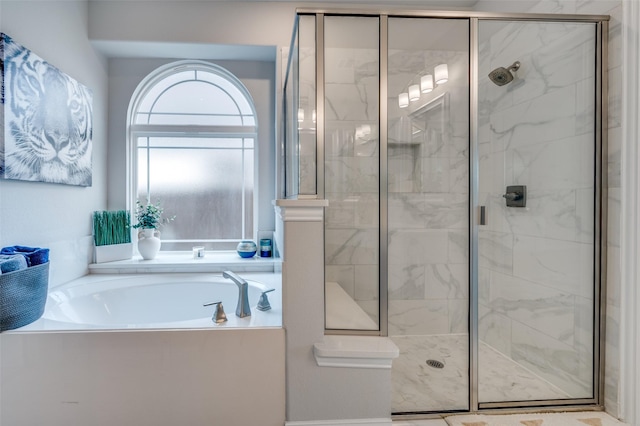full bathroom featuring a bath and a stall shower