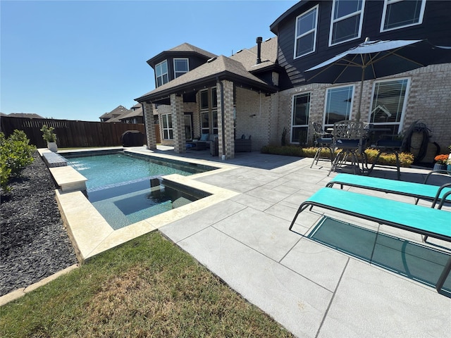 view of swimming pool with a patio, an in ground hot tub, a fenced in pool, and a fenced backyard