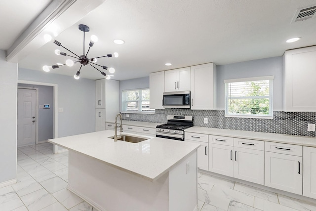 kitchen with visible vents, stainless steel appliances, marble finish floor, and a sink