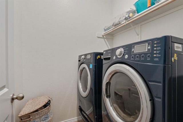 laundry room with washer and dryer, baseboards, and laundry area