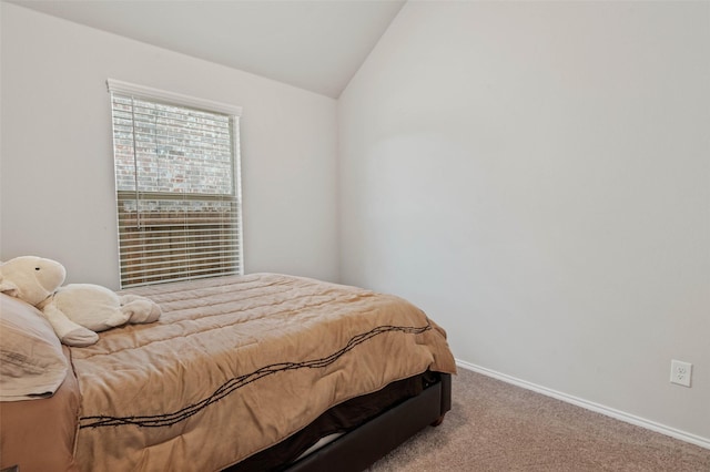 carpeted bedroom featuring vaulted ceiling and baseboards