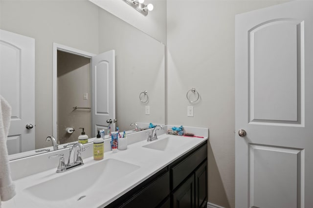 bathroom with a sink and double vanity