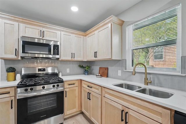 841 Lake Terrace Cir, Dallas, TX 75218 - kitchen with appliances with stainless steel finishes, a sink, light brown cabinetry, light countertops, and recessed lighting