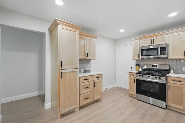 841 Lake Terrace Cir, Dallas, TX 75218 - kitchen with appliances with stainless steel finishes, light brown cabinets, light wood-style floors, light countertops, and baseboards