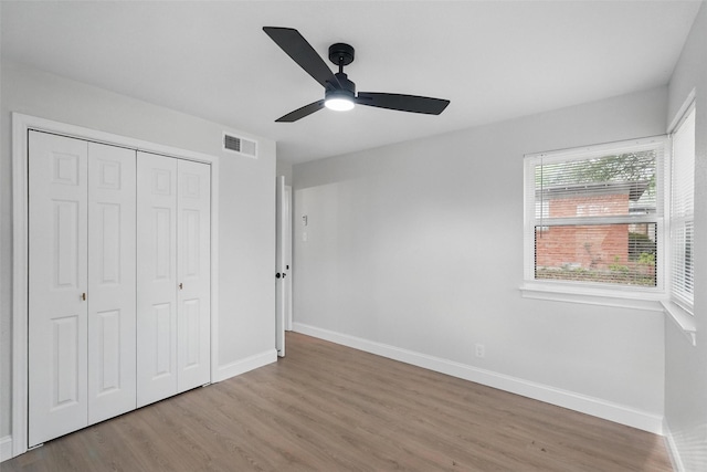 841 Lake Terrace Cir, Dallas, TX 75218 - unfurnished bedroom featuring wood finished floors, baseboards, a closet, and a ceiling fan