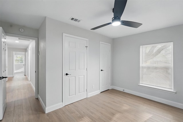 841 Lake Terrace Cir, Dallas, TX 75218 - unfurnished bedroom with light wood-type flooring, baseboards, and a ceiling fan