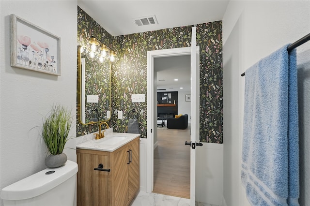 841 Lake Terrace Cir, Dallas, TX 75218 - half bath with vanity, toilet, and marble look tiles