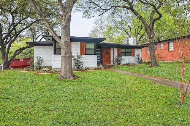 841 Lake Terrace Cir, Dallas, TX 75218 - view of front facade featuring brick siding, a front lawn, and a chimney