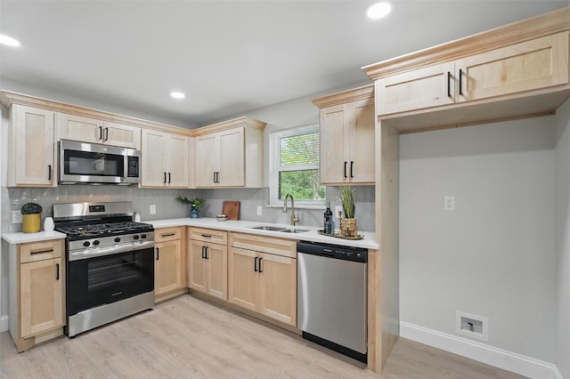 841 Lake Terrace Cir, Dallas, TX 75218 - kitchen featuring stainless steel appliances, light brown cabinets, a sink, light wood finished floors, and tasteful backsplash