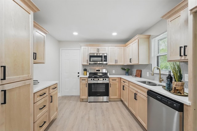 841 Lake Terrace Cir, Dallas, TX 75218 - kitchen featuring appliances with stainless steel finishes, light brown cabinetry, a sink, light wood-type flooring, and light countertops