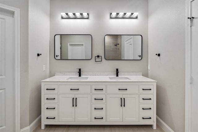 208 Splitrail Dr, Mabank, TX 75143 - bathroom featuring baseboards, a sink, and double vanity