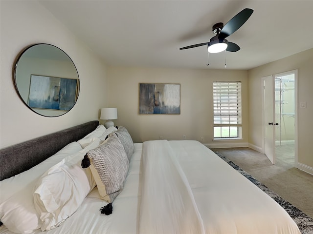 carpeted bedroom featuring ceiling fan, baseboards, and ensuite bathroom