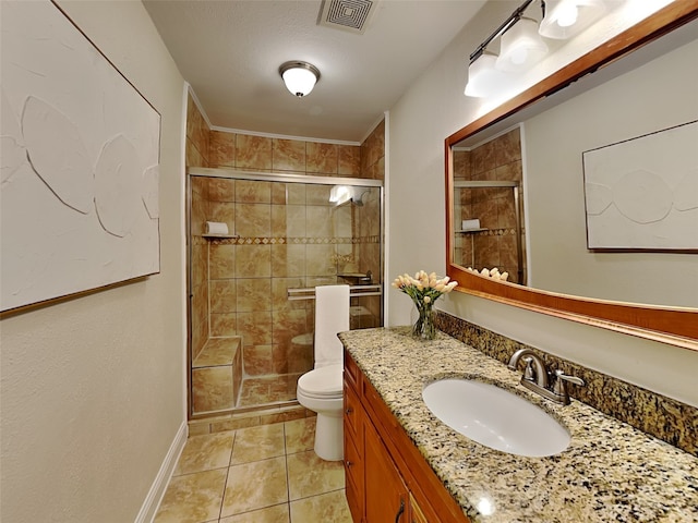 full bathroom with tile patterned floors, a stall shower, vanity, toilet, and visible vents