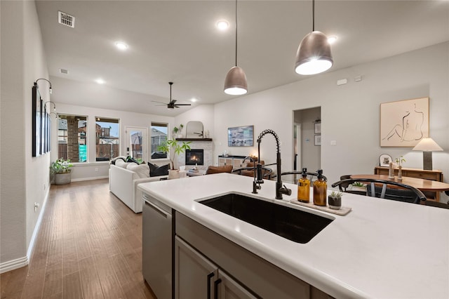 11721 Bull Creek Dr, Northlake, TX 76226 - kitchen featuring a glass covered fireplace, light countertops, decorative light fixtures, dishwasher, and recessed lighting