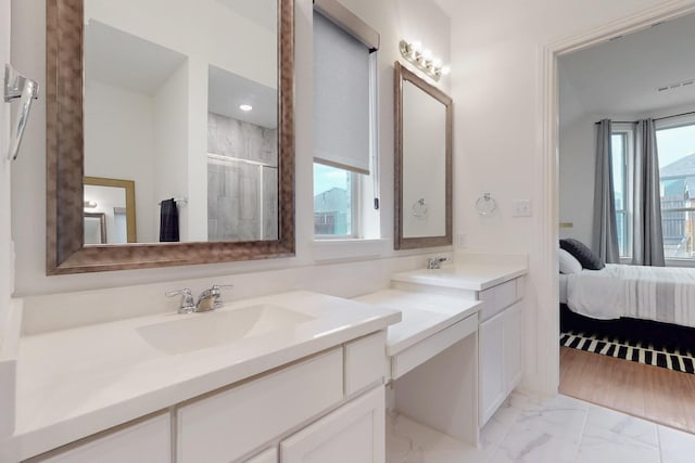 bathroom with ensuite bathroom, a tile shower, vanity, and marble finish floor