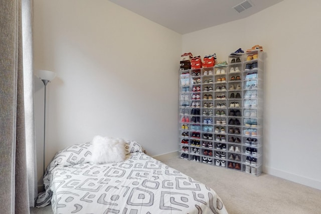 bedroom with visible vents and carpet