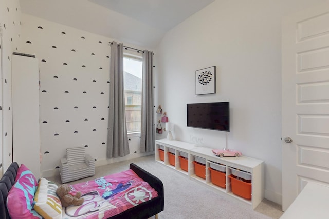 bedroom featuring light colored carpet and lofted ceiling