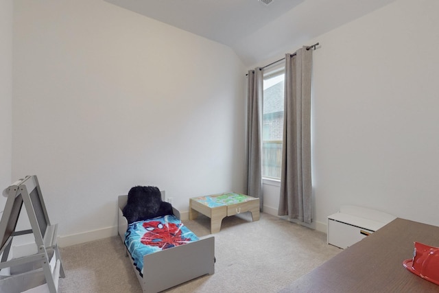 bedroom featuring baseboards, vaulted ceiling, and light carpet