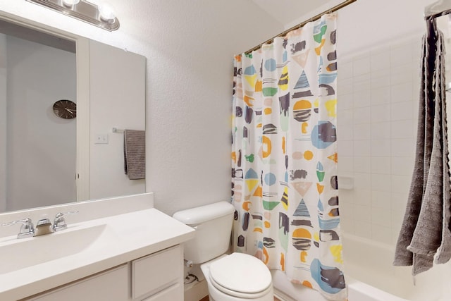 bathroom featuring shower / tub combo with curtain, toilet, a textured wall, and vanity