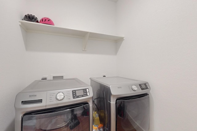 laundry area with washing machine and clothes dryer and laundry area