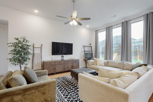 living area featuring visible vents, light wood-type flooring, ceiling fan, and recessed lighting