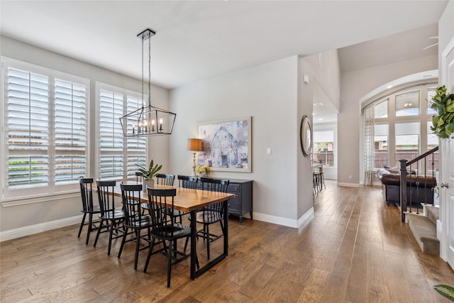dining space with wood finished floors, a healthy amount of sunlight, and baseboards