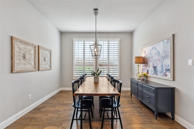 dining area featuring baseboards and dark wood-type flooring