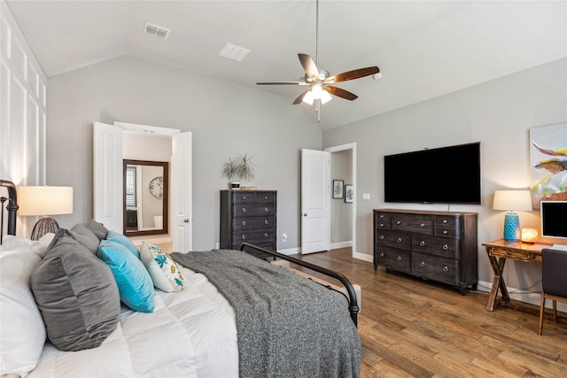 bedroom featuring lofted ceiling, wood finished floors, visible vents, and a ceiling fan