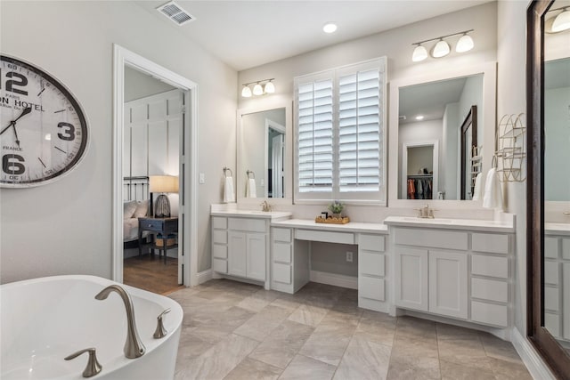 bathroom with a soaking tub, vanity, visible vents, recessed lighting, and ensuite bath