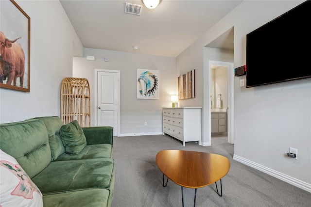 carpeted living room featuring visible vents and baseboards