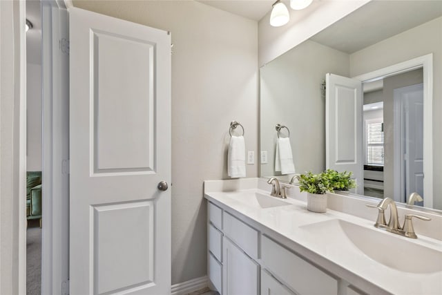 full bath featuring double vanity and a sink