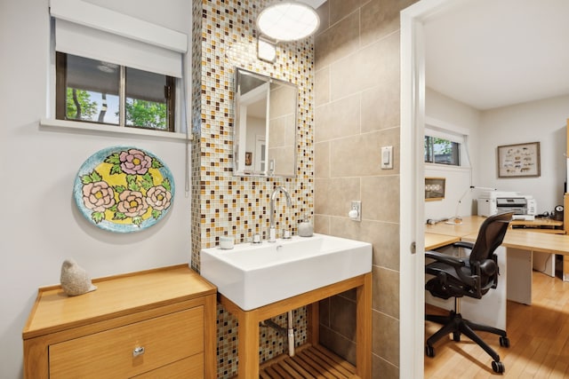 bathroom with tile walls and wood finished floors