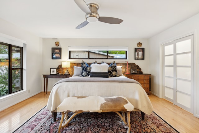 bedroom featuring light wood-style flooring, baseboards, and ceiling fan