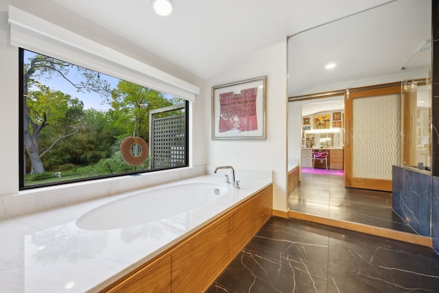 bathroom with recessed lighting, lofted ceiling, a bath, and marble finish floor
