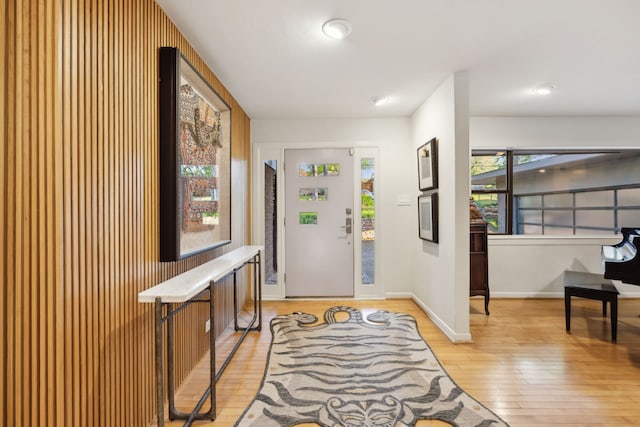 foyer with light wood finished floors and baseboards