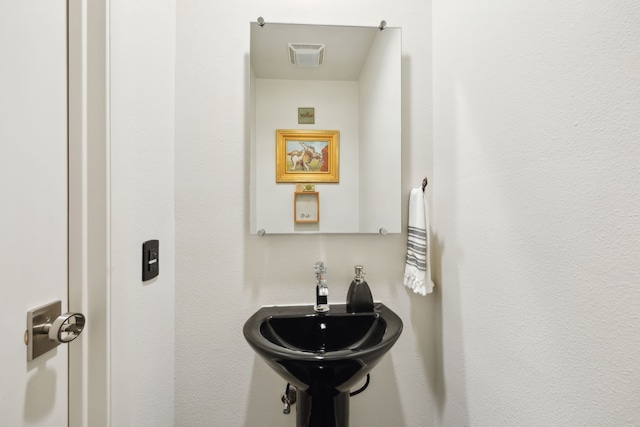 bathroom featuring visible vents and a sink