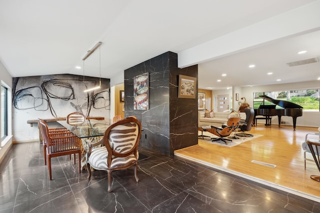 dining area with recessed lighting, visible vents, marble finish floor, and stone wall