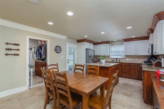 113 S Hill Top Ct, Springtown, TX 76082 - dining room with baseboards, recessed lighting, a textured ceiling, and ornamental molding