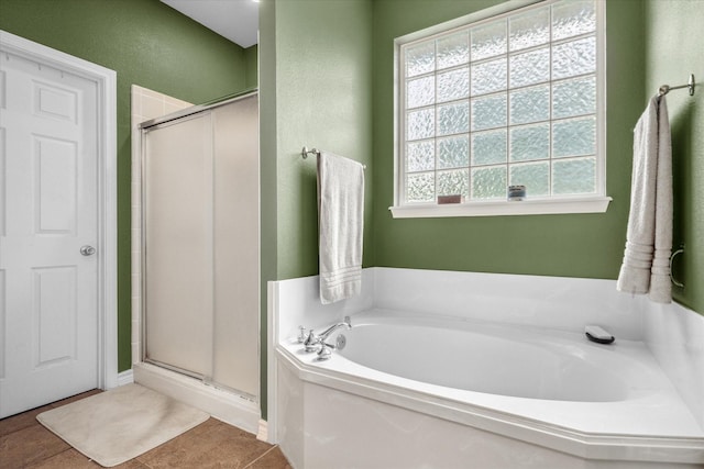 bathroom with a bath and a shower stall