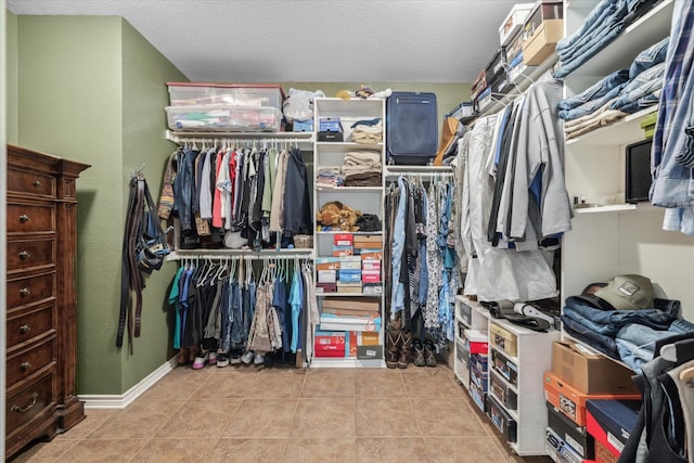 walk in closet with tile patterned flooring