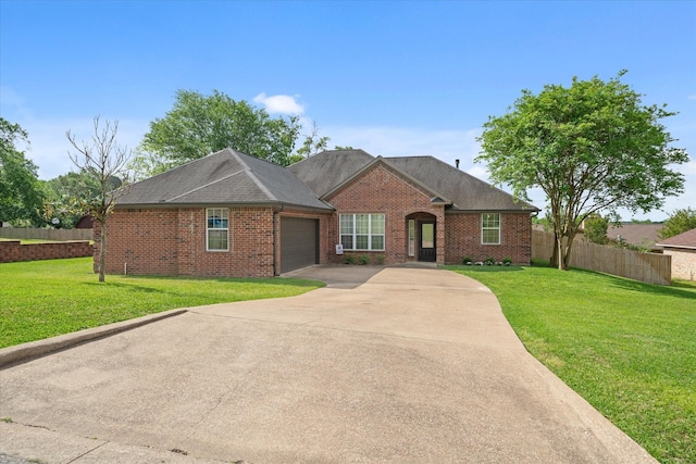 ranch-style house with an attached garage, fence, driveway, and a front lawn