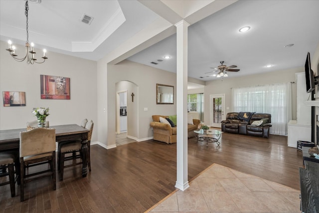dining area with arched walkways, visible vents, recessed lighting, ceiling fan with notable chandelier, and wood finished floors