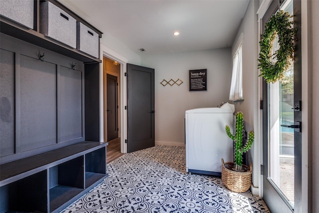 laundry area with plenty of natural light, baseboards, laundry area, and washer / clothes dryer