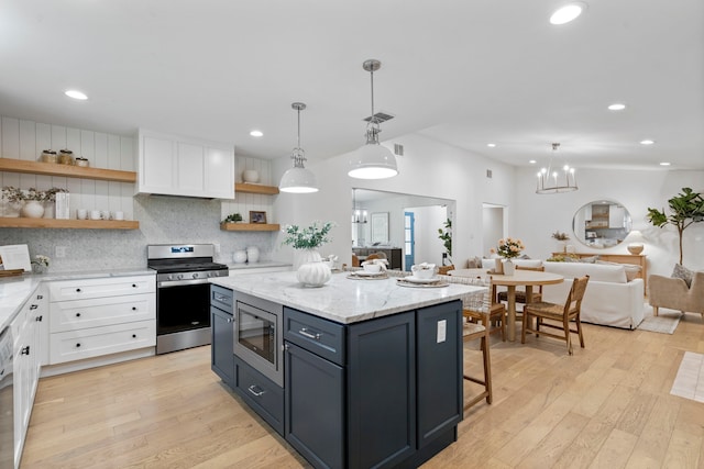 kitchen featuring open shelves, light wood finished floors, white cabinetry, and appliances with stainless steel finishes