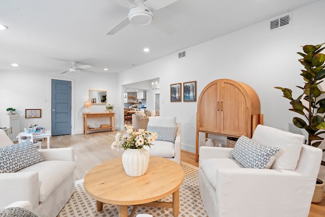 living area with recessed lighting, visible vents, light wood finished floors, and ceiling fan